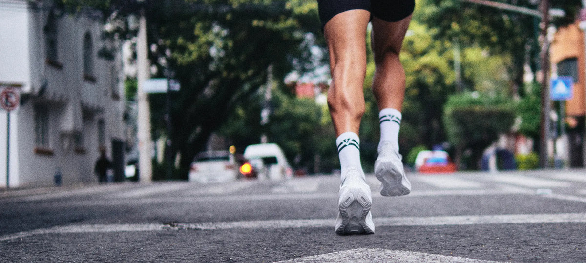 Corredor con calcetas deportivas VEROZ blancas en una calle de la ciudad